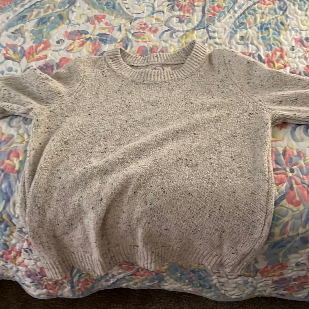 Alya large sweater has buttons on each sleeve